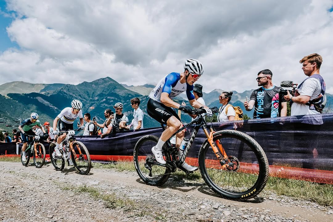 Racing through a mountain switchback in the World Cup peloton